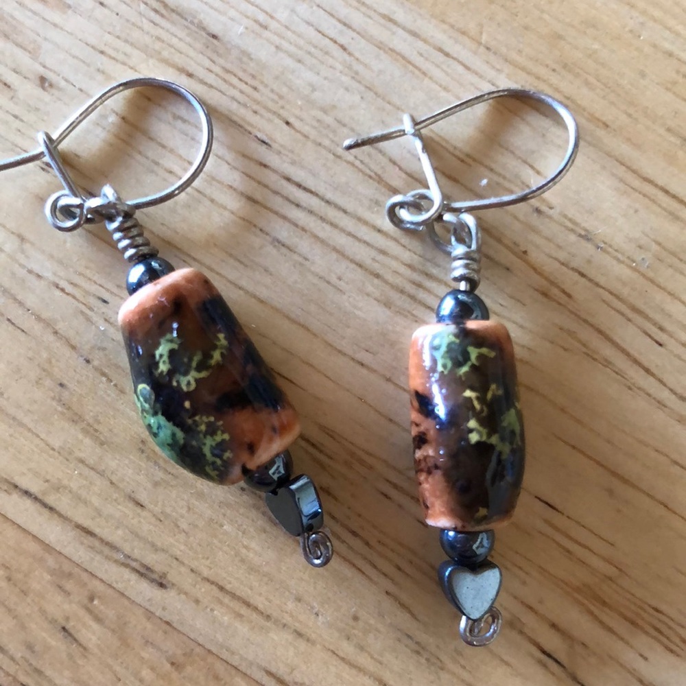 Lovely ceramic earrings in brown and green tones with a small heart below